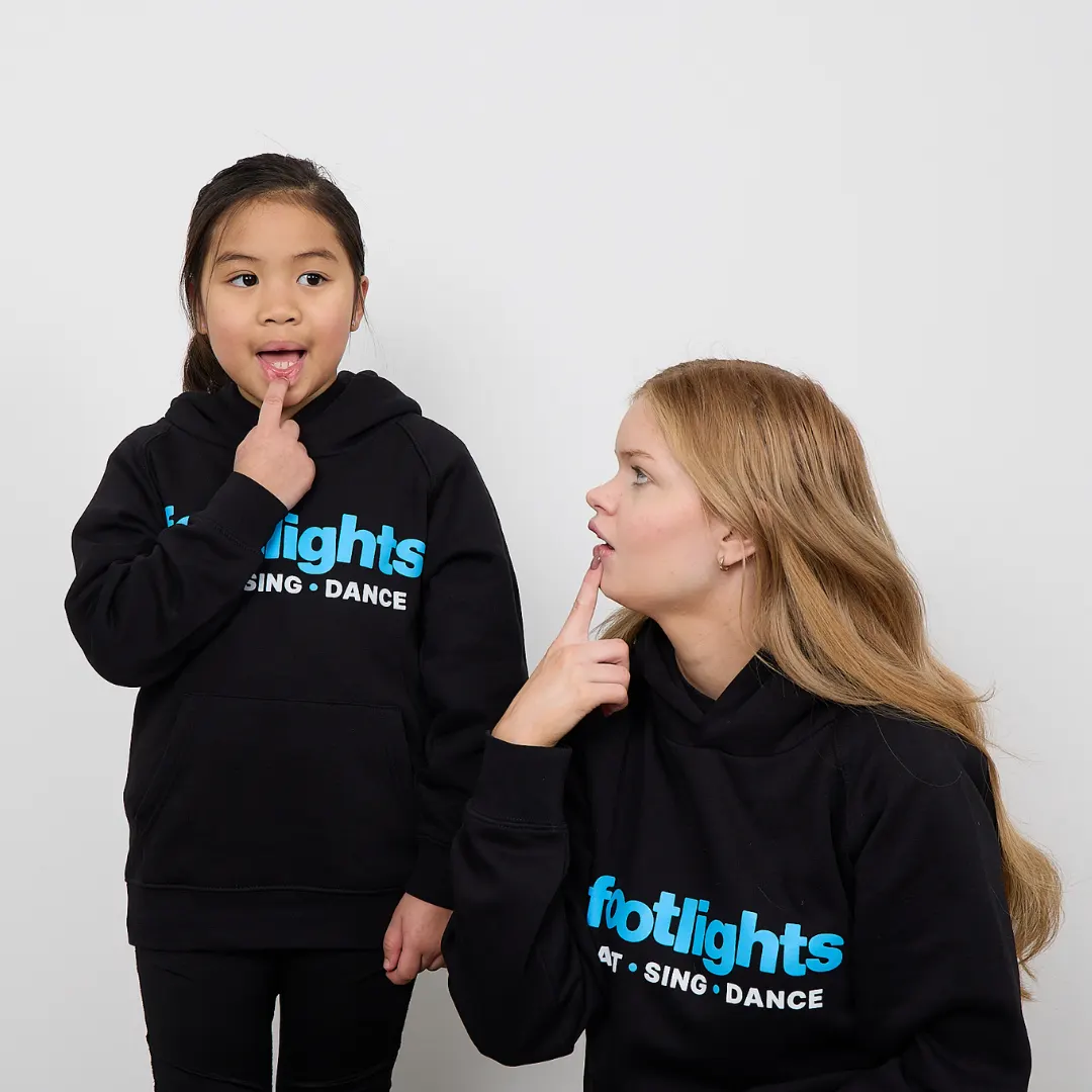 Footlights Tinys taking part in a singing class